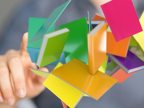 Person pointing at many different books