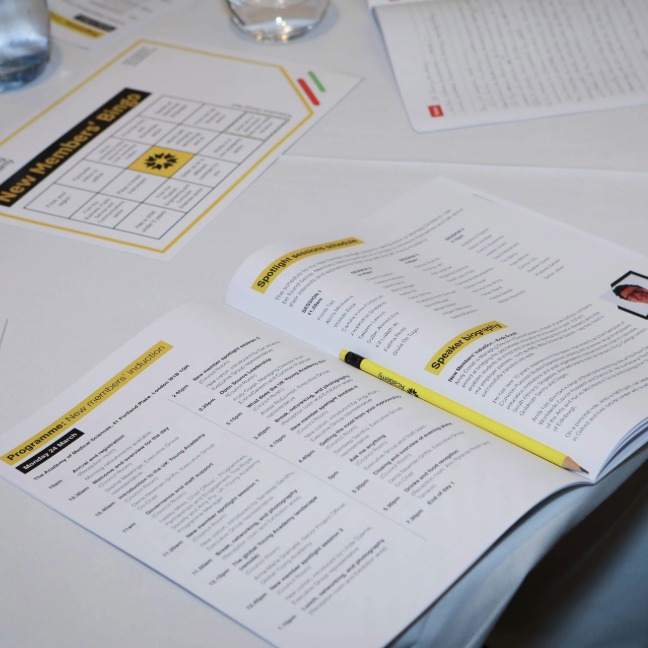 An open induction day booklet on a table