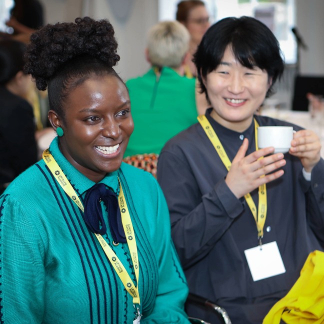 All members meeting with smiling members sitting around a table together