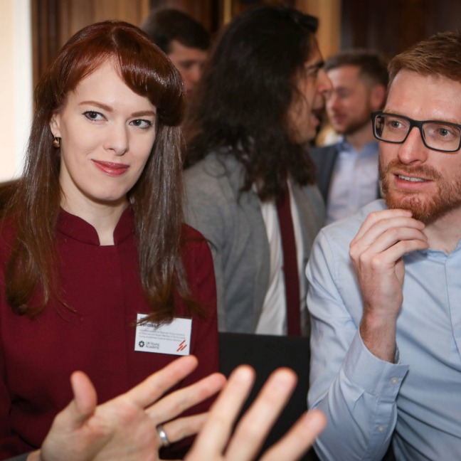 Members discuss with each other at meeting