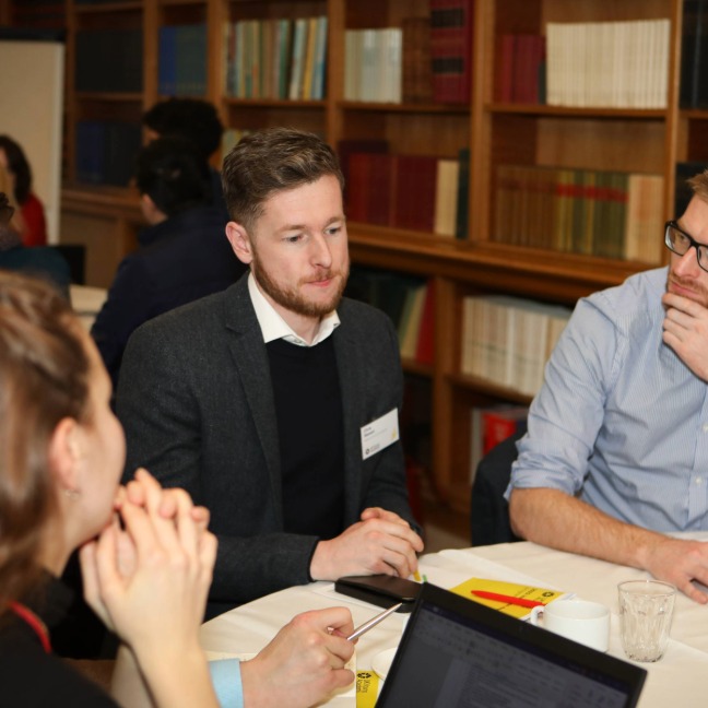 Members discuss together at a meeting