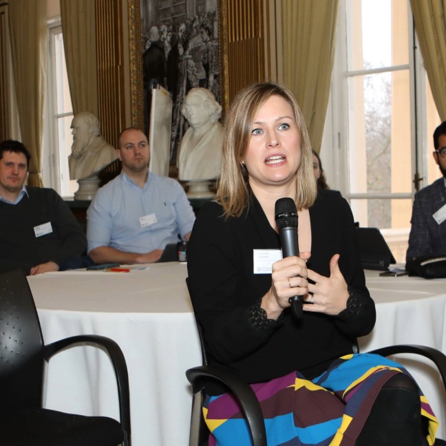 A member has the microphone during a meeting