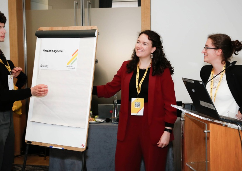 Staff and UK Young Academy members work together on a flip chart