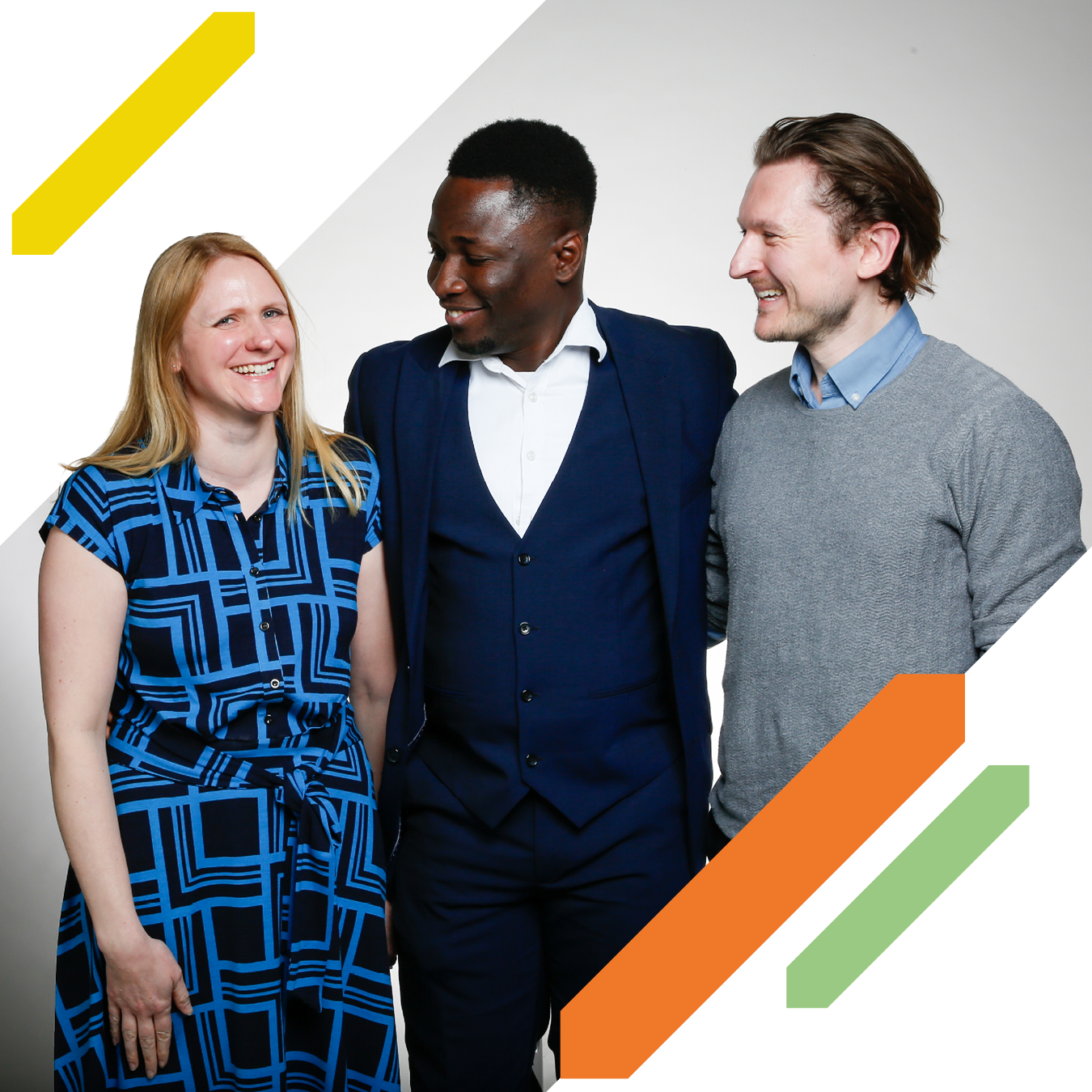 Three UK Young Academy members standing together and looking towards one another during a group photo.