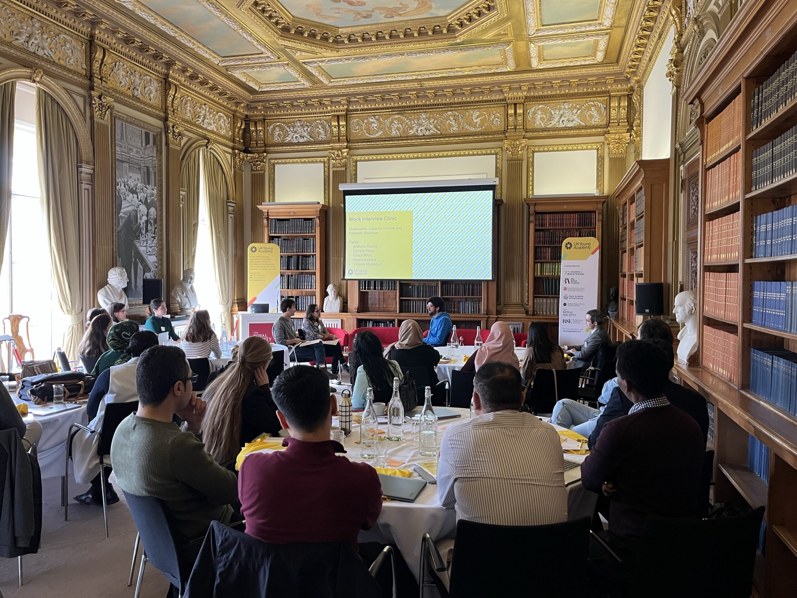 People sit and attend a workshop about mock interviews for At Risk Scholars and professionals